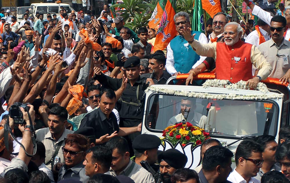 Narendra Modi greets supporters during a rally before filing his nomination for the upcoming general election in Vadodara.