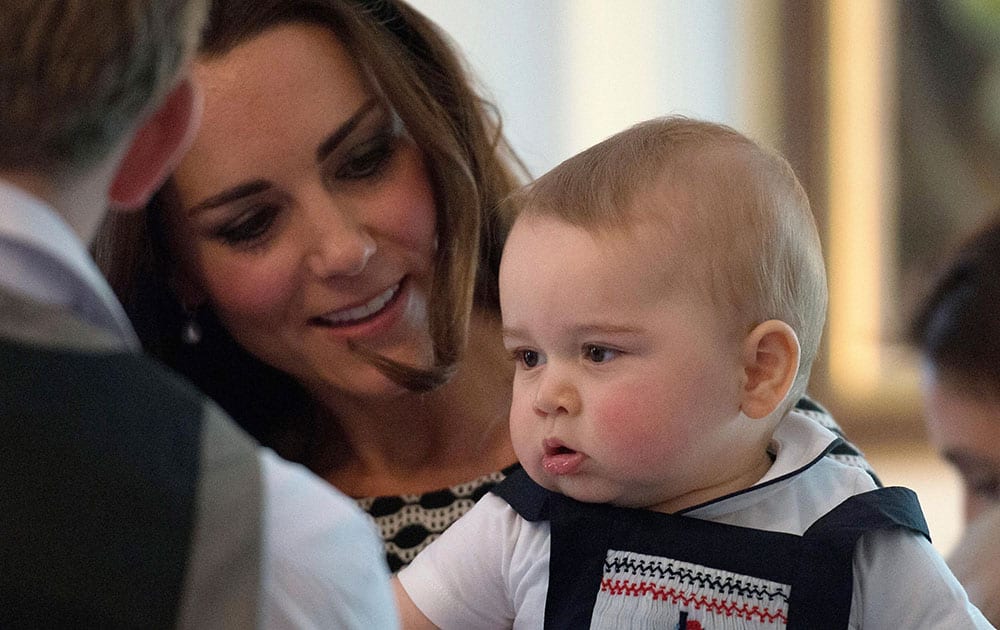 Britain`s Kate, the Duchess of Cambridge, holds Prince George during a visit to Plunket nurse and parents group at Government House in Wellington, New Zealand.