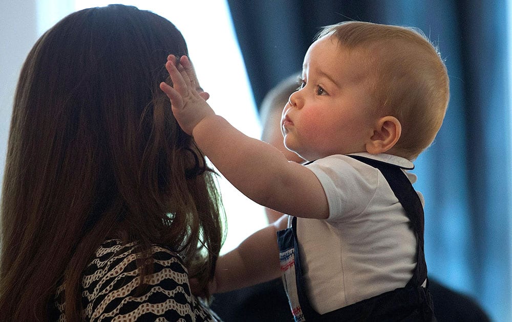 Britain`s Kate, the Duchess of Cambridge, holds Prince George during a visit to Plunket nurse and parents group at Government House in Wellington, New Zealand.