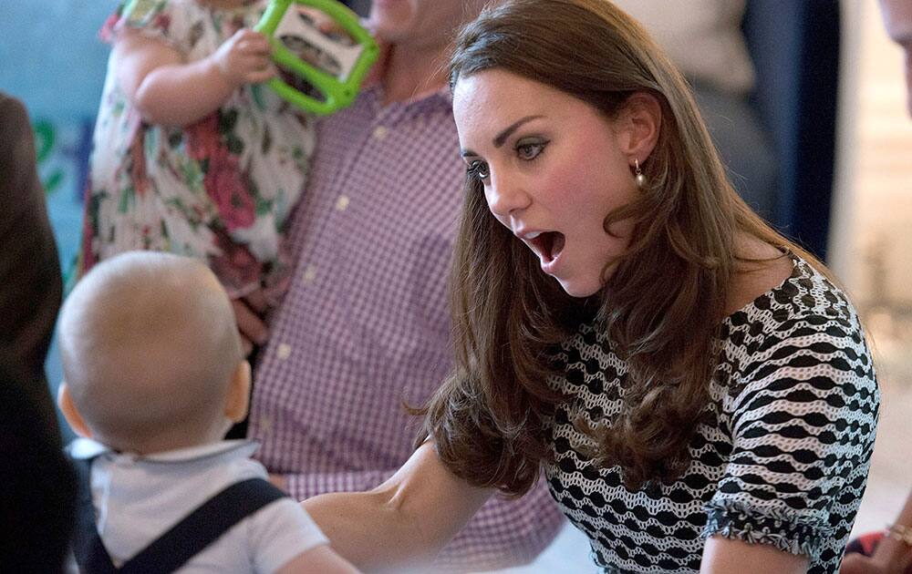 Britain`s Prince George, left, plays with his mother, Kate, the Duchess of Cambridge, during a visit to Plunket nurse and parents group at Government House in Wellington, New Zealand.