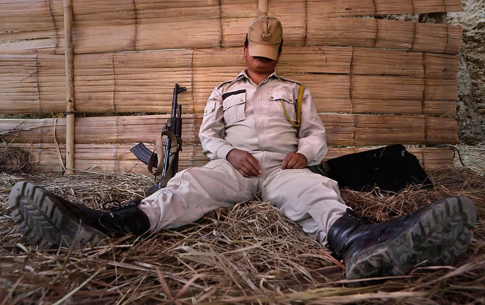A security man rests at an electronic voting machine distribution center on the eve of the second phase of Indian parliamentary elections at Senapati, in north eastern Manipur state.