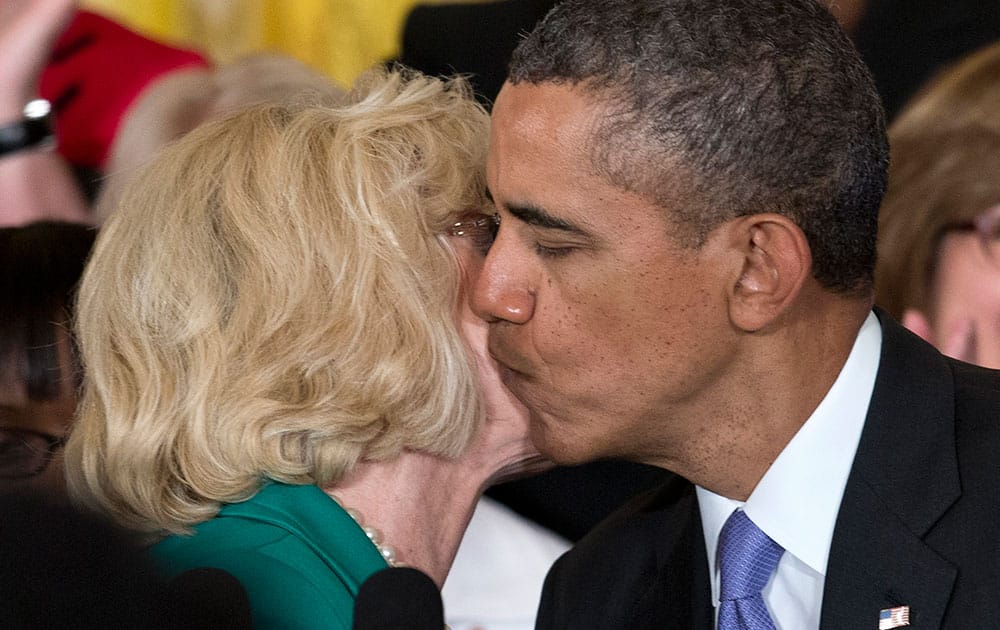 President Barack Obama kisses Women’s rights activist Lilly Ledbetter on the cheek in the East Room of the White House in Washington, during an event marking Equal Pay Day, and where the president will announce and sign new executive actions to strengthen enforcement of equal pay laws for women.