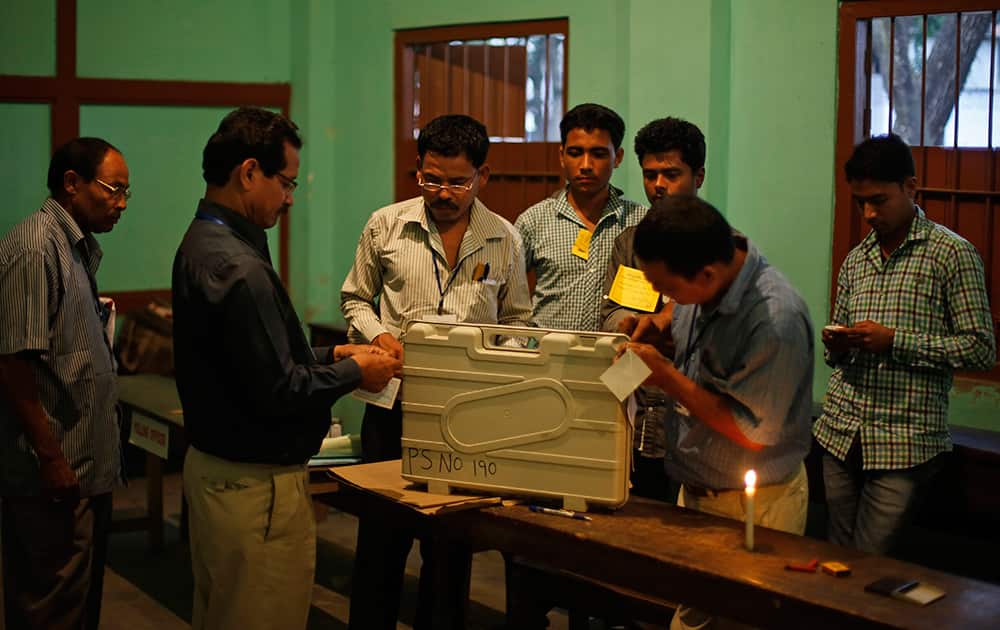 Election officials seal an electronic voting machine and other material at the end of the first phase of elections in Dibrugarh, in the northeastern state of Assam.