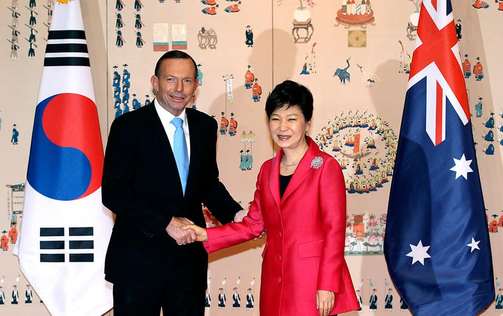 Australian Prime Minister Tony Abbott shakes hands with his South Korean counterpart Park Geun-hye before their meeting at the presidential house in Seoul, South Korea.