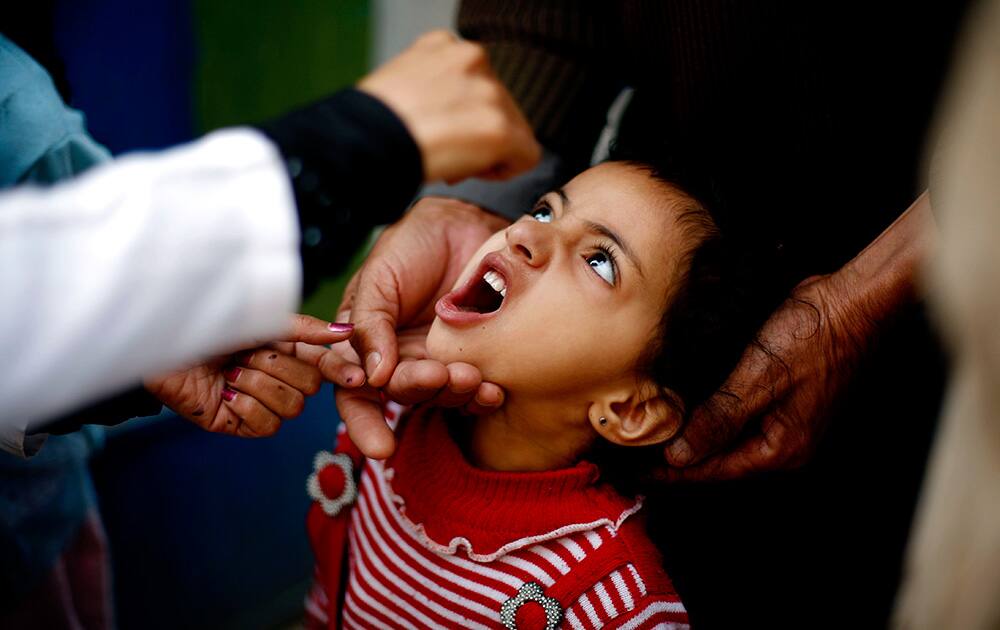 A Yemeni girl receives a polio vaccination during a house to house polio immunization campaign in Sanaa, Yemen.
