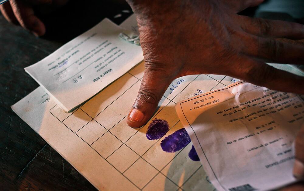 A man puts his thumb impression before casting his vote during the first phase of elections in Agartala, in the northeastern state of Tripura.