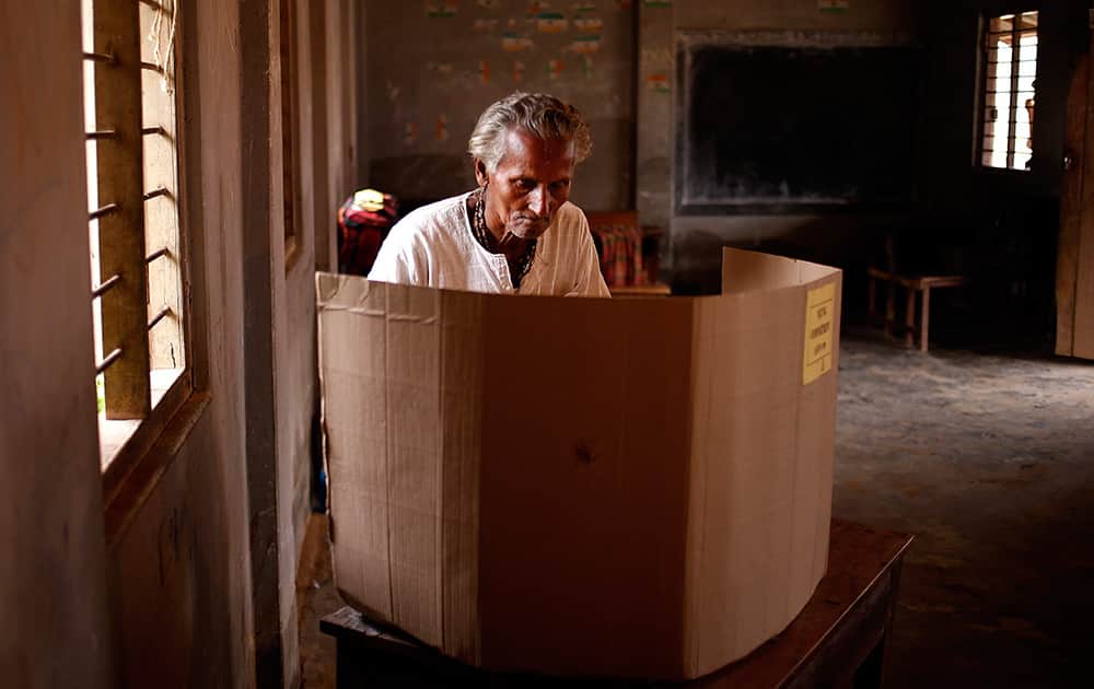 A man casts his vote during the first phase of elections in Agartala, in the northeastern state of Tripura.