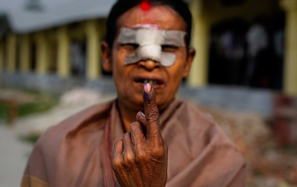 An elderly woman displays her indelible ink mark on her finger after casting her vote outside a polling station during the first phase of elections in Dibrugarh, in the northeastern state of Assam.