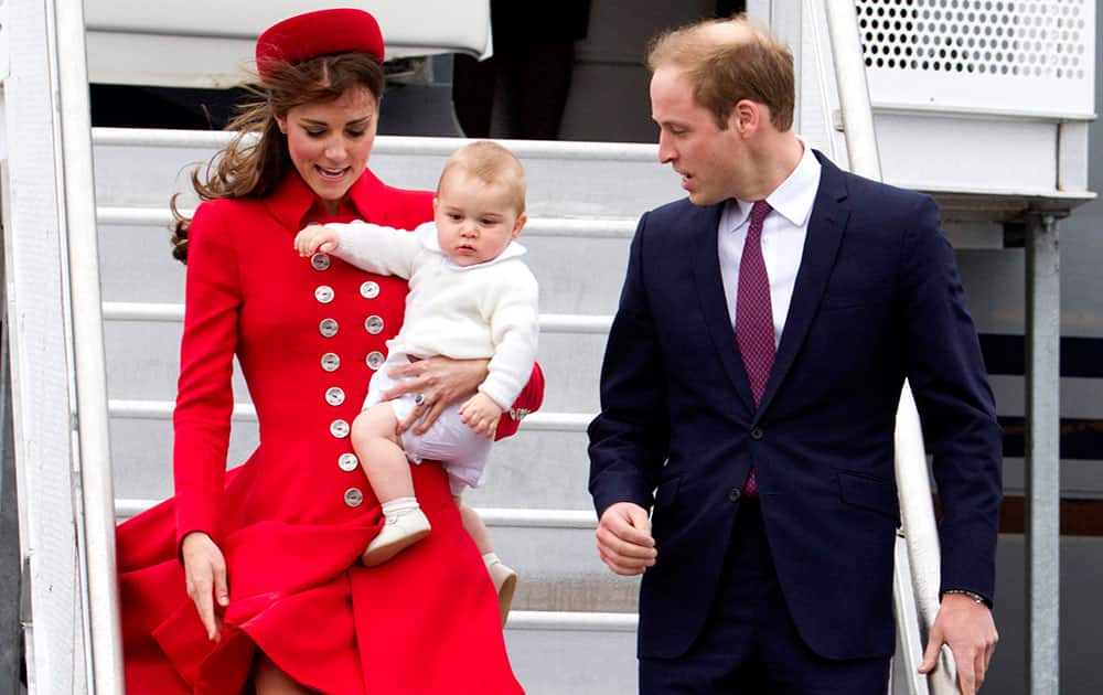 Britain`s Prince William and his wife Kate, the Duchess of Cambridge with Prince George arrive for their visit to New Zealand at the International Airport, in Wellington, New Zealand.