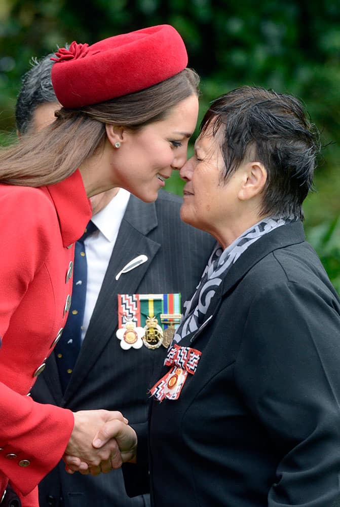 Britain`s Kate, the Duchess of Cambridge, left, receives a hongi, a traditional Maori welcome, from Maori Elder Hiria Hape, at the official welcome ceremony for Kate and her husband Prince William, at Government House, in Wellington, New Zealand.