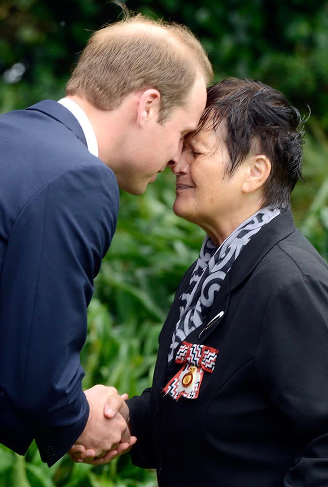 Britain`s Prince William, left, receives a hongi, a traditional Maori welcome, from Maori Elder Hiria Hape, at the official welcome ceremony for William and his wife Kate, at Government House, in Wellington, New Zealand.