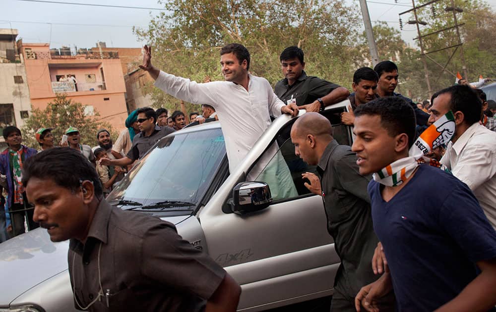Congress party vice president Rahul Gandhi waves to supporters while leaving after an election rally in New Delhi.