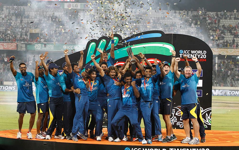 Sri Lanka’s players and team officials pose for a group photo while celebrating with the trophy after winning the ICC Twenty20 Cricket World Cup in Dhaka.
