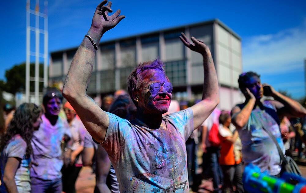 A man enjoys the atmosphere of the festival at the Holi Festival of Colours in Barcelona, Spain. The festival is fashioned after the Hindu spring festival Holi, which is mainly celebrated in the north and east of India.