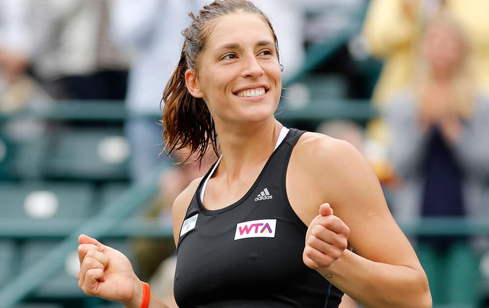 Andrea Petkovic, of Germany, reacts after defeating Jana Cepelova, of Slovakia, in two sets during the Family Circle Cup tennis tournament final in Charleston, S.C.