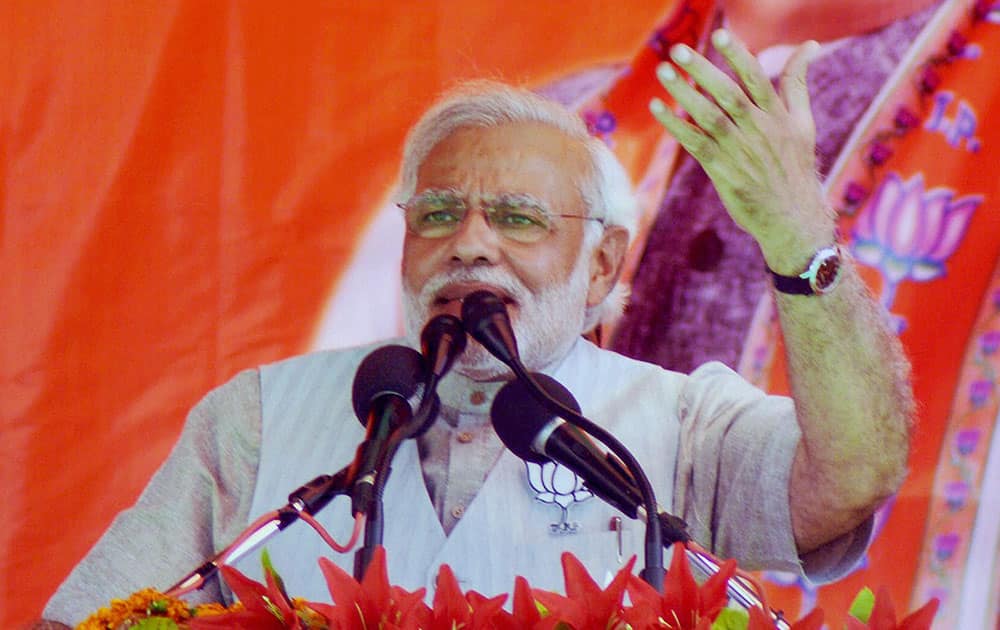 BJP Prime Ministerial candidate Narendra Modi addresses an election rally at Exibition Ground hailing BJP`s Etah candidate Rajveer Singh `Raju in Aligarh.