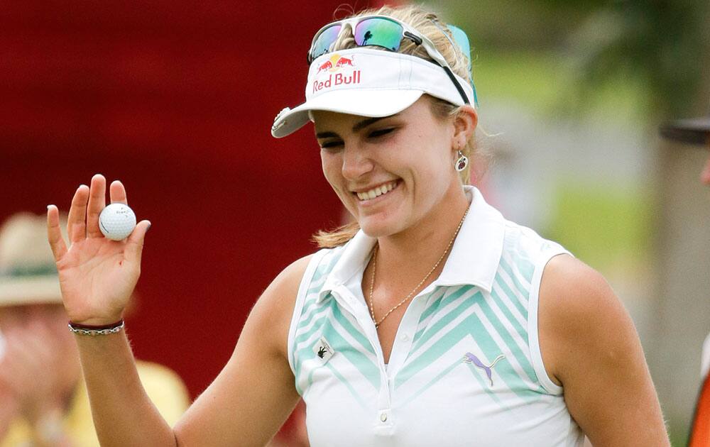 Lexi Thompson waves after a birdie on the ninth hole during the second round of the Kraft Nabisco Championship golf tournament.