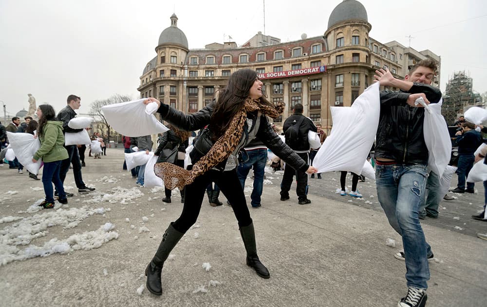 Youngsters engage in a pillow fight in downtown Bucharest, Romania. Romanians took part in large numbers in the pillow fight to mark International Pillow Fight Day.