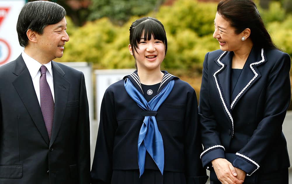 Japan`s Princess Aiko, center, accompanied by her parents Crown Prince Naruhito, left, and Crown Princess Masako, answers a reporter`s question as they attend her entrance ceremony at the Gakushuin Girls` Junior High School in Tokyo.