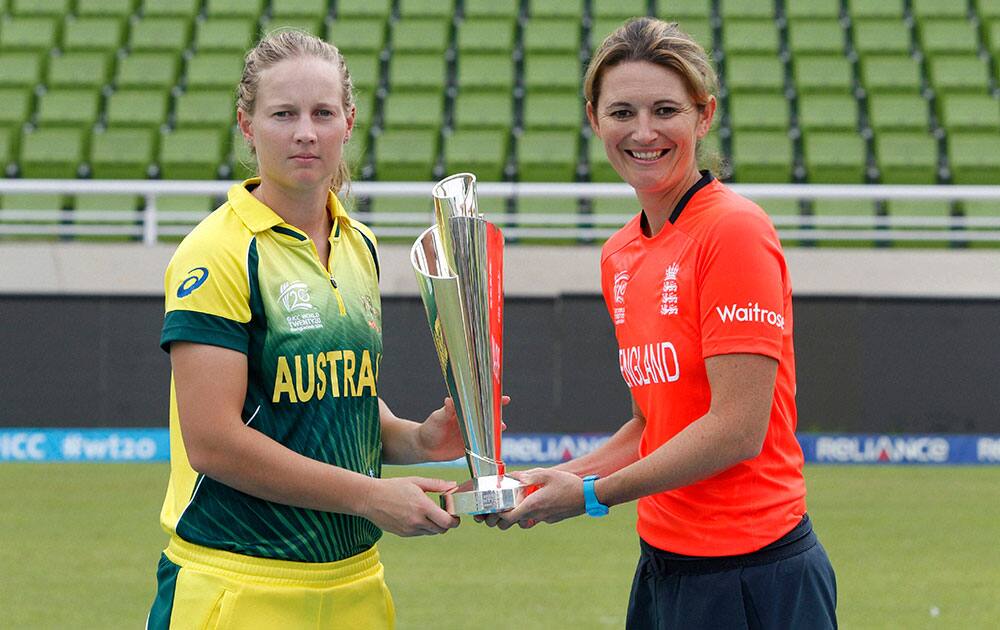 Australian women`s cricket captain Meg Lanning, left, and England women`s cricket captain Charlotte Edwards pose with the trophy ahead of their ICC Twenty20 Cricket World Cup final match in Dhaka, Bangladesh.