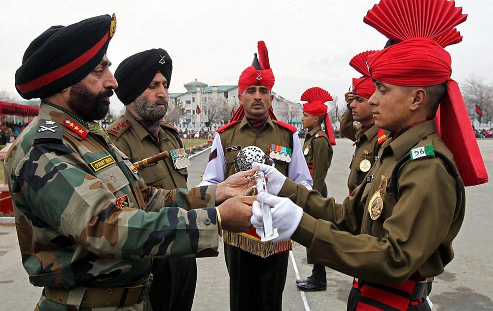 15 corps commander GoC Gurmeet Singh awards the Sher-e-Kashmir, Sword of Honour to recruit Vicky Singh after the passing out parade at Jammu and Kashmir Light Infantry Regimental Centre, in Srinagar.