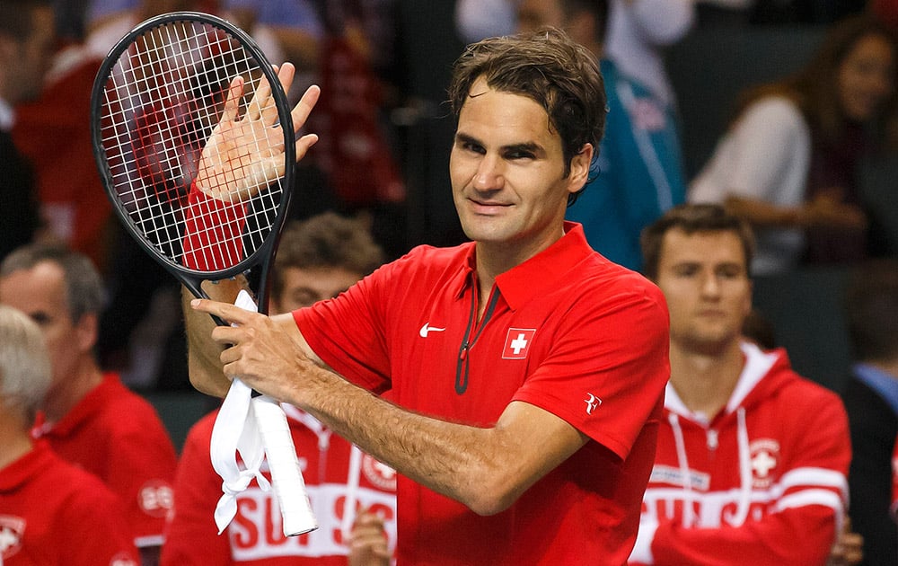 Roger Federer, of Switzerland, celebrates after beating Mikhail Kukushkin of Kazakhstan during the second single match of the Davis Cup World Group Quarterfinal match between Switzerland and Kazakhstan in Geneva, Switzerland.