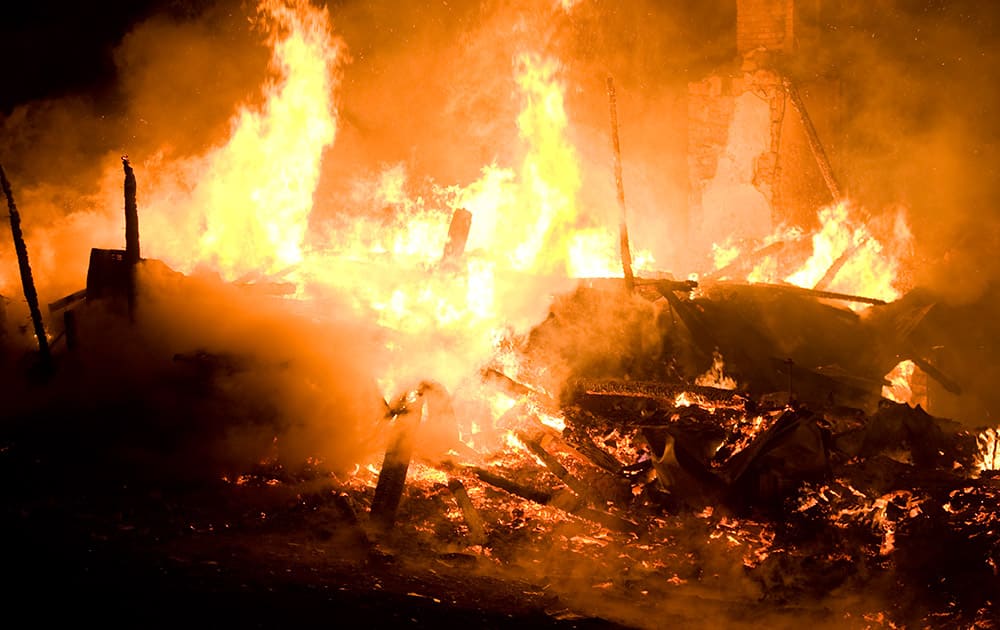 Fire destroys a house on Friday, April 4, 2014 outside Danville, Pa. The early morning farmhouse fire in north-central Pennsylvania killed three children, ages 2 to 13, authorities said.