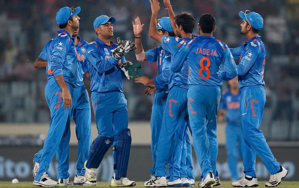 India`s players celebrate the dismissal of South Africa`s batsman Quinton de Kock during their ICC Twenty20 Cricket World Cup semi-final match in Dhaka, Bangladesh.