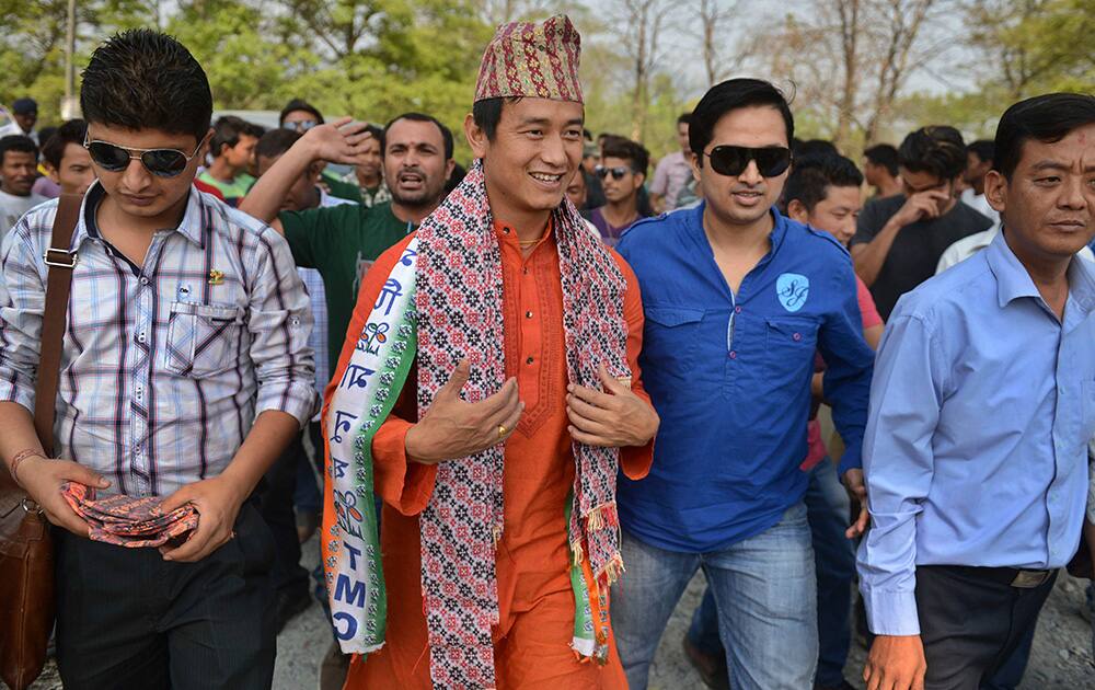 Soccer star and Trinamul Congress party candidate for the Darjeeling constituency Baichung Bhutia walks with supporters during his election campaign at Sevok Bazar, outskirts of Siliguri, West Bengal.