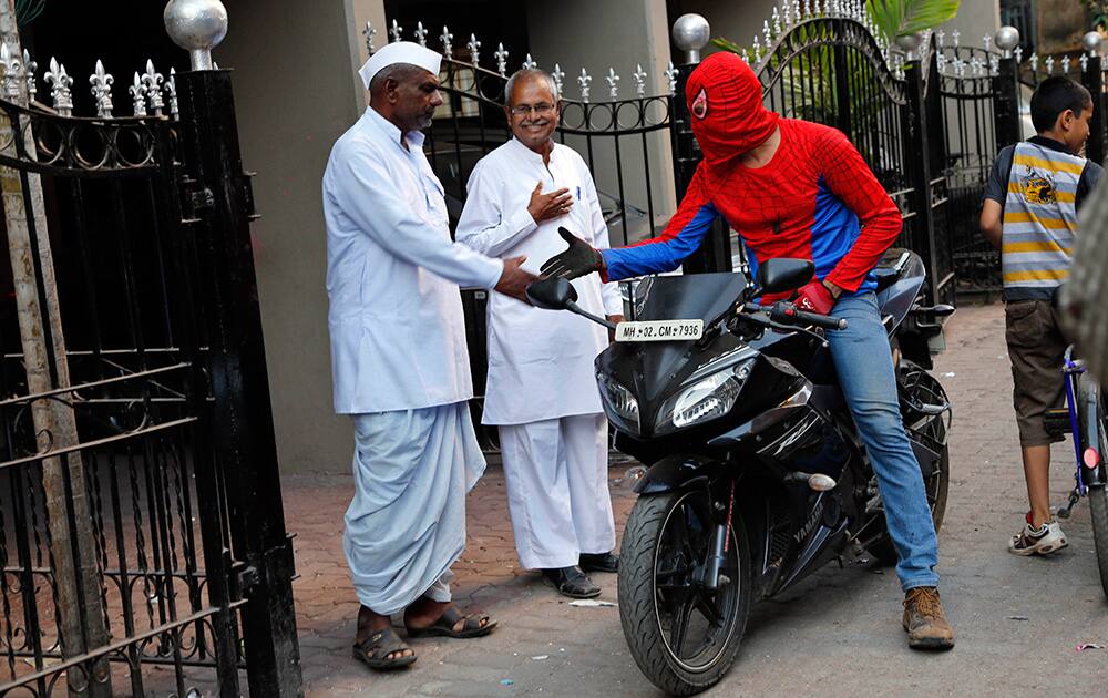 Gaurav Sharma, locally known as Indian Spiderman who is contesting as an independent candidate in the upcoming parliamentary elections greets people during his campaign in Mumbai.