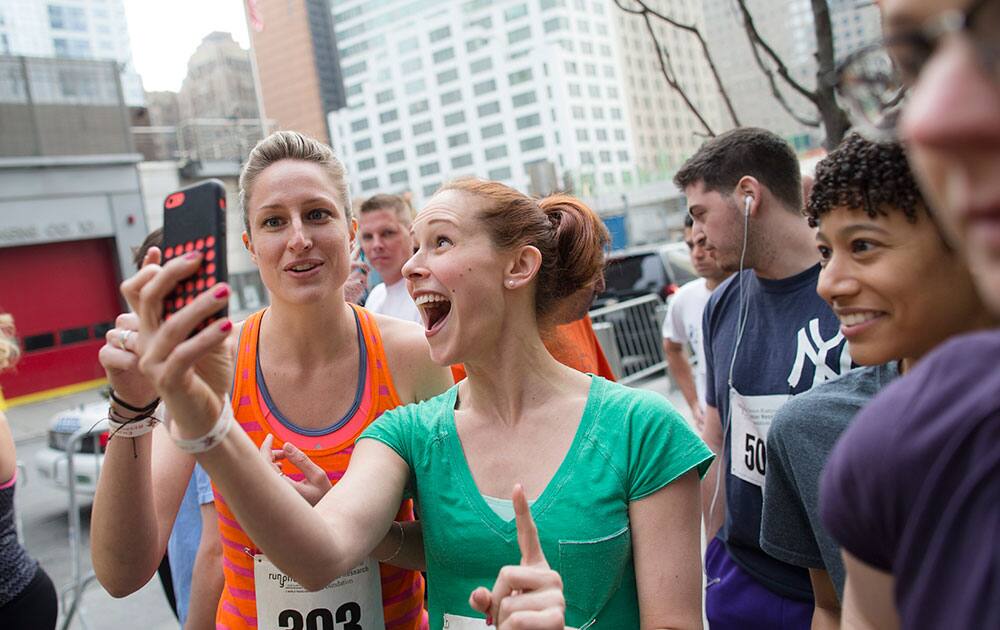 Runners take a selfie before climbing towards the 72nd floor of 4 World Trade Center during the `Runyon Up,` a fundraiser for the Damon Runyon Cancer Research Foundation, in New York.