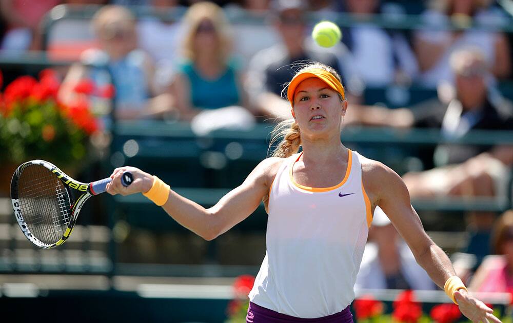 Eugenie Bouchard, of Canada, returns to Venus Williams during the Family Circle Cup tennis tournament in Charleston, S.C.