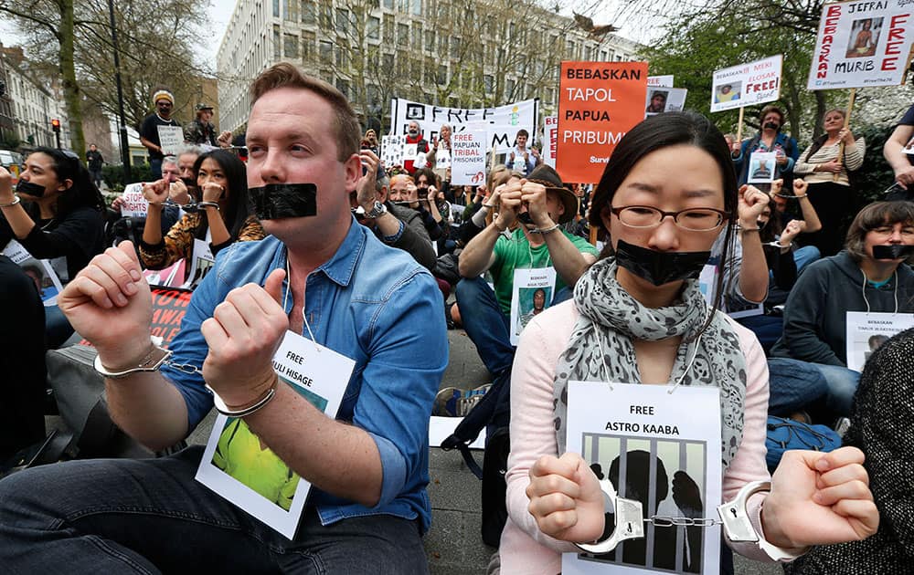 Protesters handcuffed and gagged with tape stage a rally across from the Indonesian embassy in central London, to protest the ongoing detention of 76 political prisoners in Indonesia’s West Papua province.