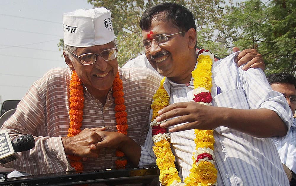 Aam Aadmi Party`s (AAP) convener Arvind Kejriwal with party candidate Rajmohan Gandhi during an election campaign rally in Delhi.