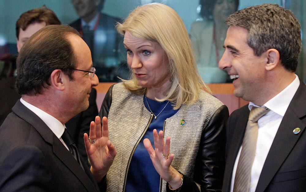 French President Francois Hollande, left, talks with Denmark`s Prime Minister Helle Thorning-Schmidt, center, and Bulgarian President Rosen Plevneliev, prior to the start of an EU-Africa summit in Brussels.