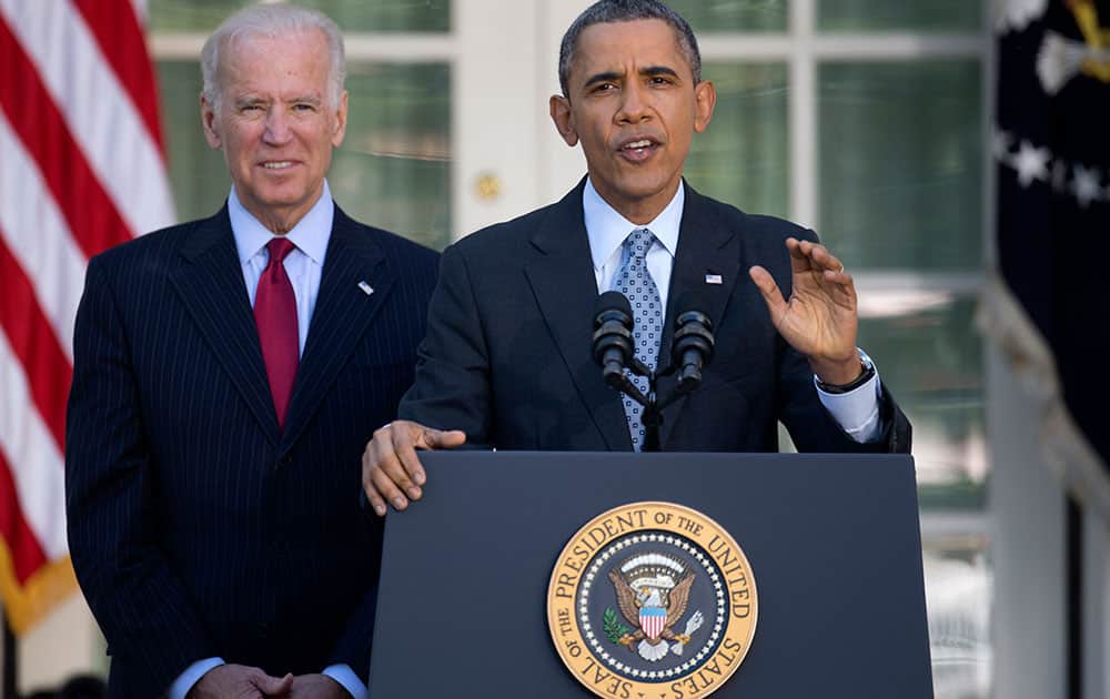 President Barack Obama, with Vice President Joe Biden, gestures as he speaks in the Rose Garden of the White House in Washington, about the Affordable Care Act. The deadline to sign up for health insurance under the Affordable Care Act passed at midnight Monday night.