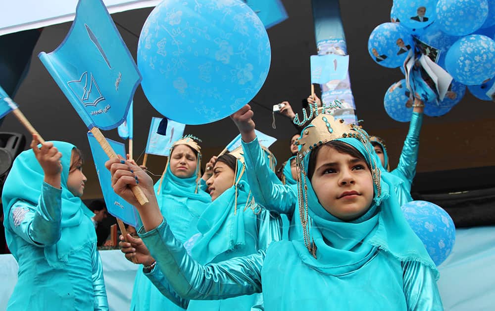 Afghan girls hold flags during a campaign rally for Afghan presidential candidate Abdullah Abdullah in Herat, Afghanistan.