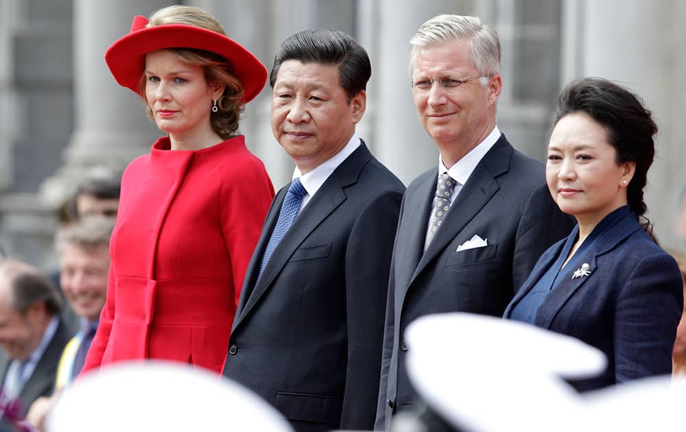 China`s President Xi Jinping, second left, his wife Peng Liyuan, right, Belgian King Philippe and his wife Queen Mathilde, attend a ceremony on a podium at the Burg square in Bruges, Belgium.