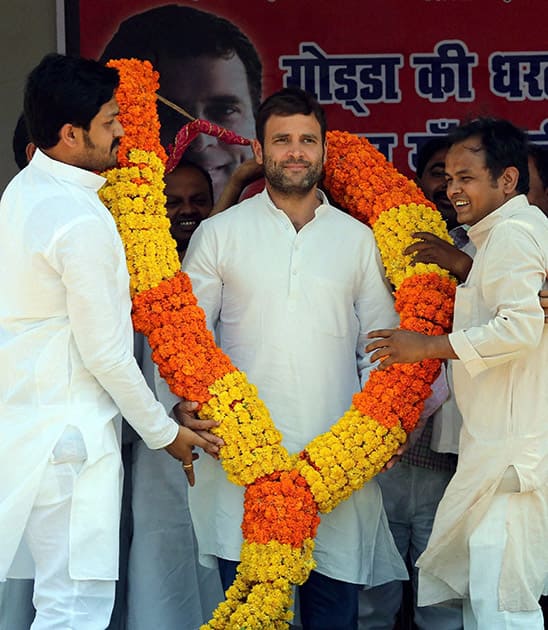 Rahul Gandhi, Vice President of All India Congress Committee (AICC) being garlanded by the party workers during an election campaign rally at Godda constituency in Jharkhand.