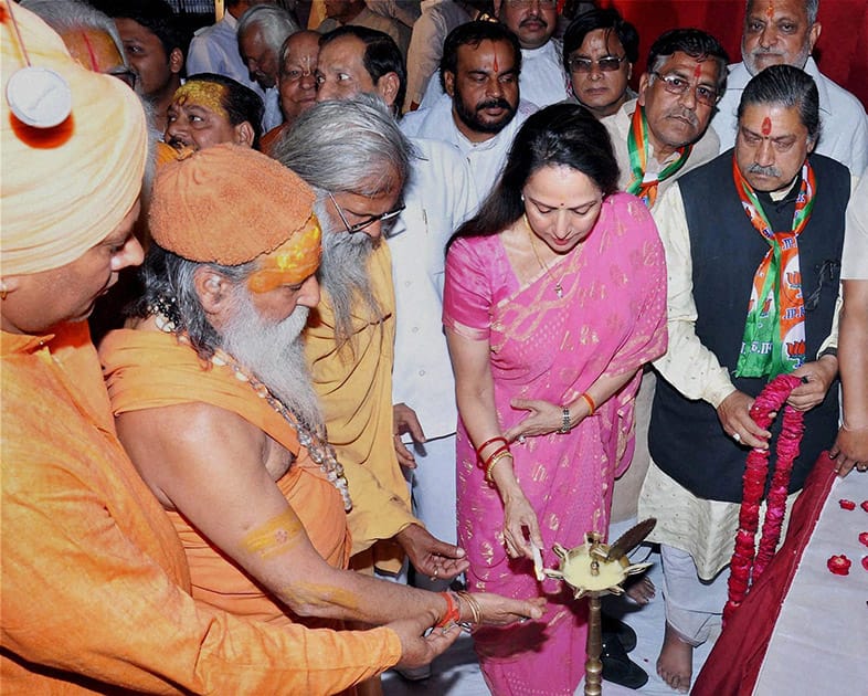 BJP Candidate and Bollywood actress Hema Malini lighting lamp along with priests during her election campaign in Mathura.