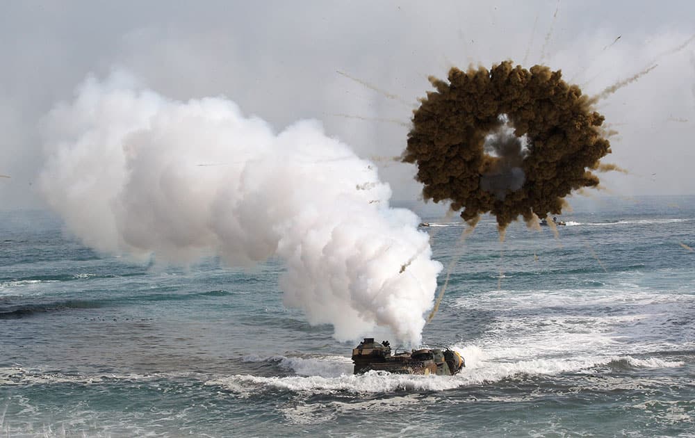 A South Korean marine LVT-7 landing craft sail to shores through a smoke screen during the US-South Korea joint landing exercises called Ssangyong, part of the Foal Eagle military exercises, in Pohang, South Korea.