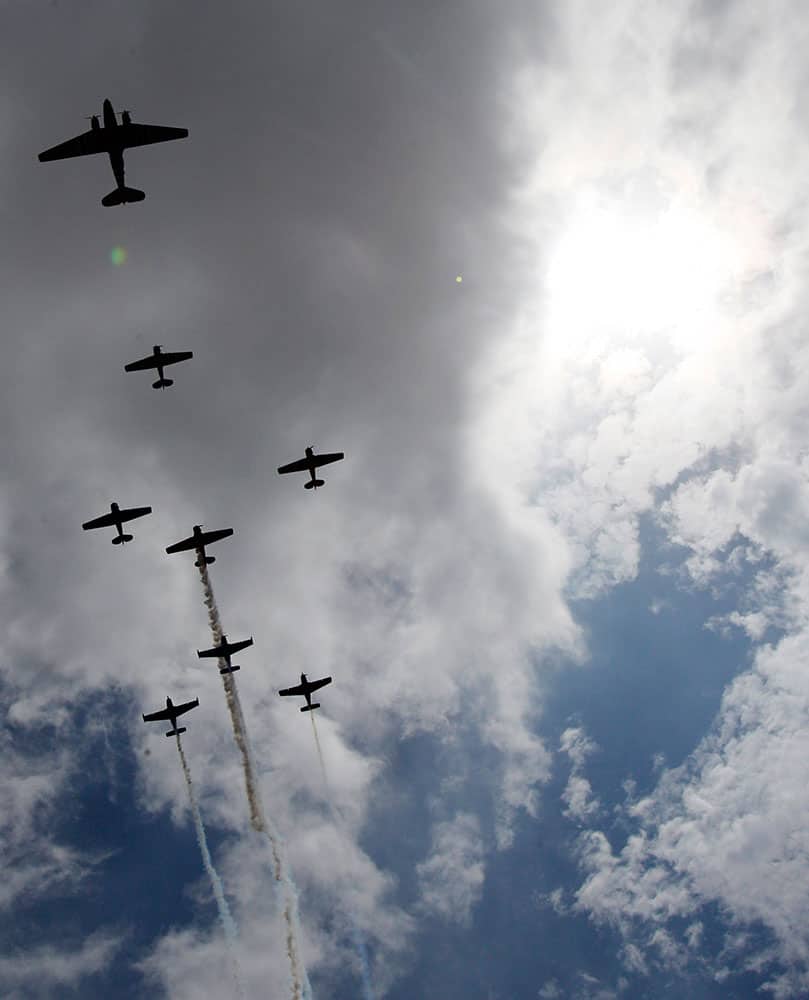 Vintage planes from the Cavanaugh Flight Museum fly over Globe Life Park before an opening day baseball game between the Texas Rangers and the Philadelphia Phillies.