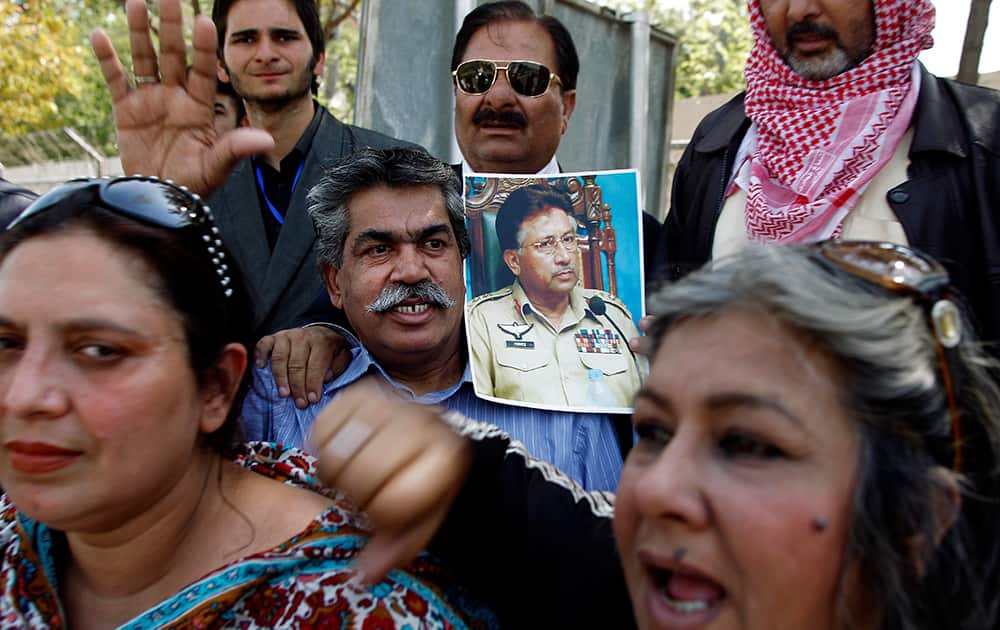 Supporters of the former Pakistani President Pervez Musharraf chant slogans outside the special court in Islamabad, Pakistan.