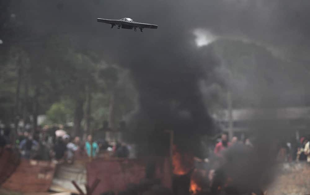 A drone flies during a mock protest as police train for World Cup security in Brasilia, Brazil. Brazil will host the soccer tournament starting in June.