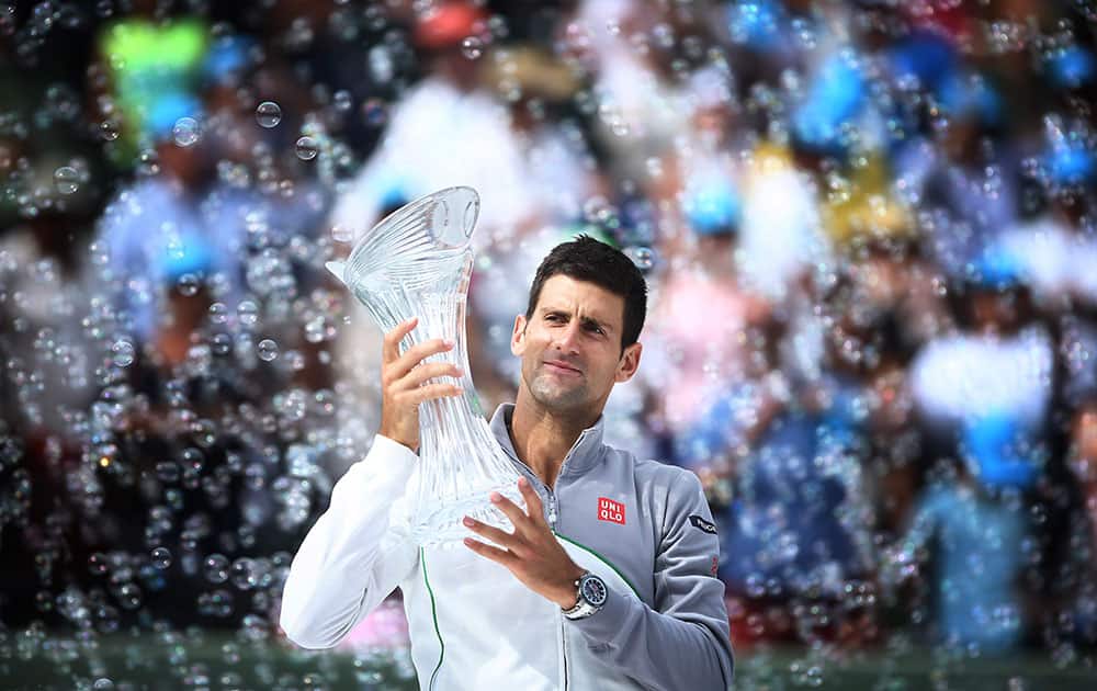 Novak Djokovic, of Serbia, holds his trophy after winning the Sony Open Tennis in Key Biscayne, Fla.