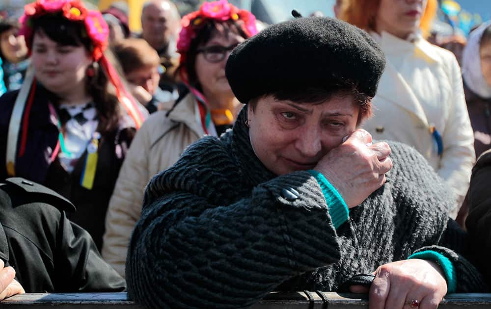 A woman cries during a mourning rally to honor the memory of those who were killed during mass protests in Kiev on Kiev`s Independence Square.