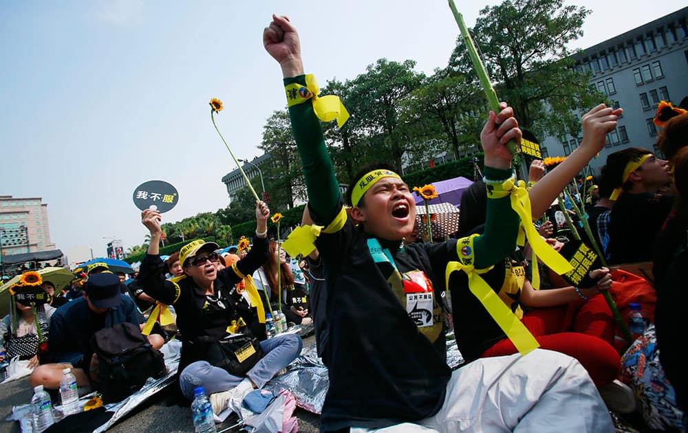 Protesters shout slogans denouncing the controversial China Taiwan trade pact during a massive protest in front of the Presidential Building in Taipei, Taiwan.