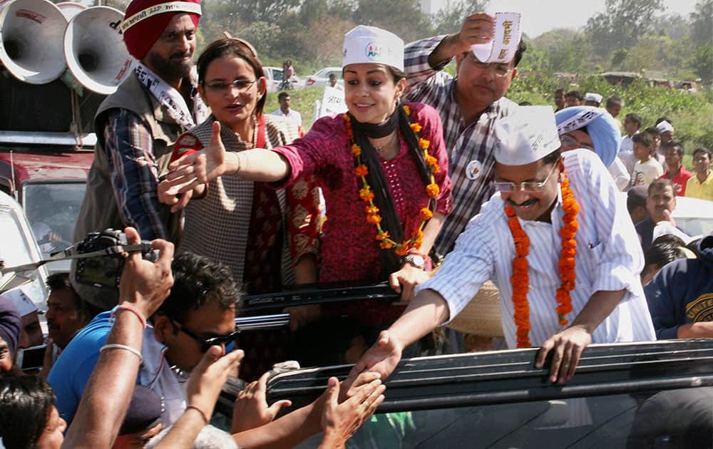 AAP convener Arvind Kejriwal with party candidate Gul Panag during an election campaign in Chandigarh.