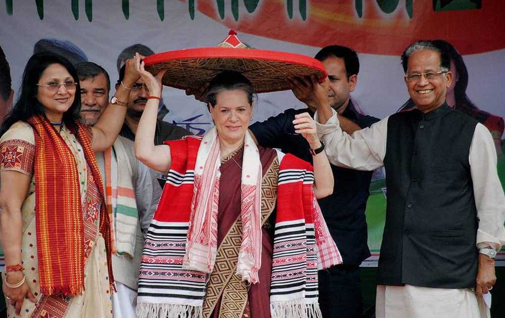 UPA Chairperson Sonia Gandhi being felicitated with traditional Assamese Japi (Hat) by Assam Chief Minister Tarun Gogoi and party leader Ranee Narah during an election campaign rally at North Lakhimpur,Assam.