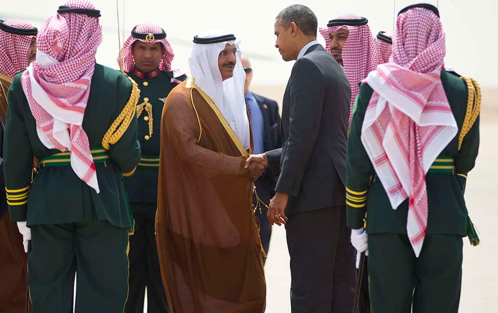 US President Barack Obama shakes hands with the Governor of Riyadh Prince Khalid Bandar bin Abdul-Aziz Al-Saud, center, during his departure on Air Force One at King Khalid International airport in Riyadh, Saudi Arabia.